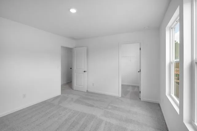 a view of an empty room and a window