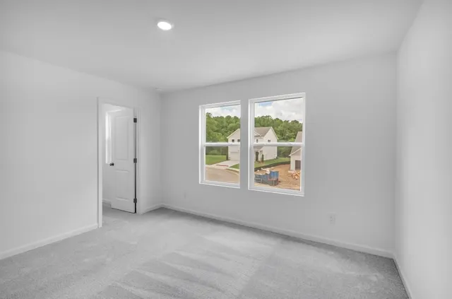 an empty room with windows and closet