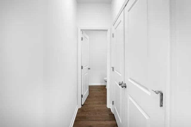 a view of a hallway with the wooden floor