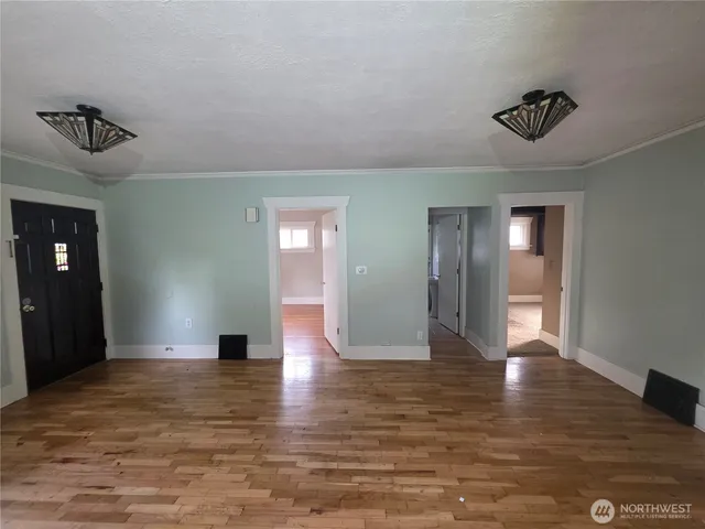 a view of empty room with wooden floor