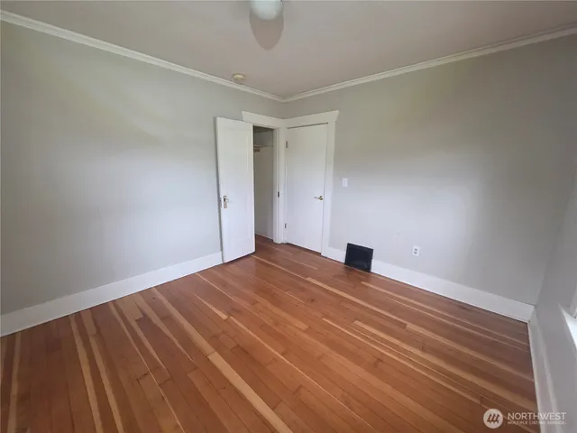 a view of an empty room and wooden floor