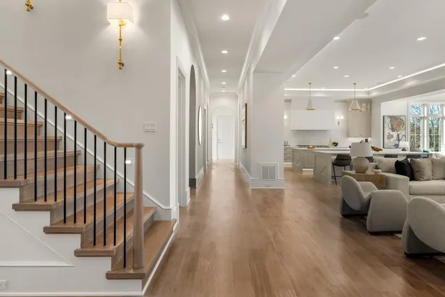 a bathroom with a granite countertop toilet sink and mirror