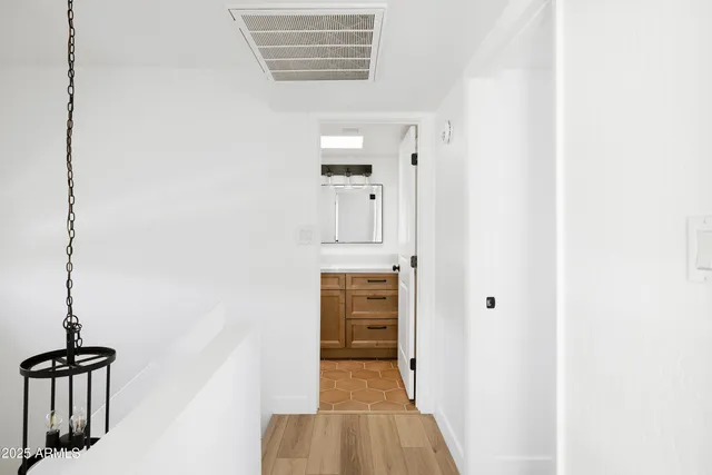 a view of hallway with stairs and wooden floor