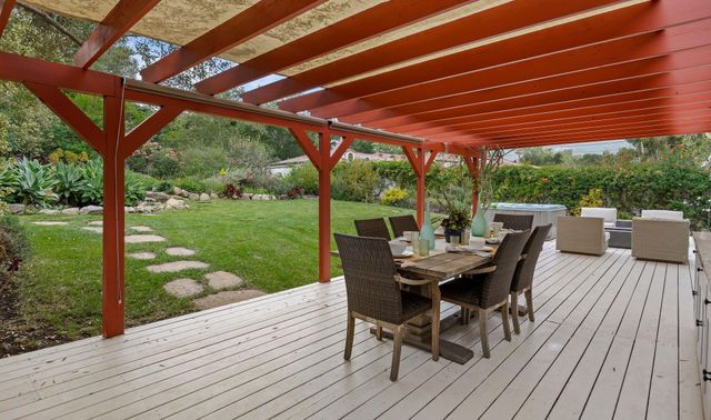 a view of a patio with table and chairs next to a yard