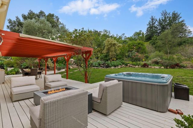 a view of a patio with couches chairs and a yard