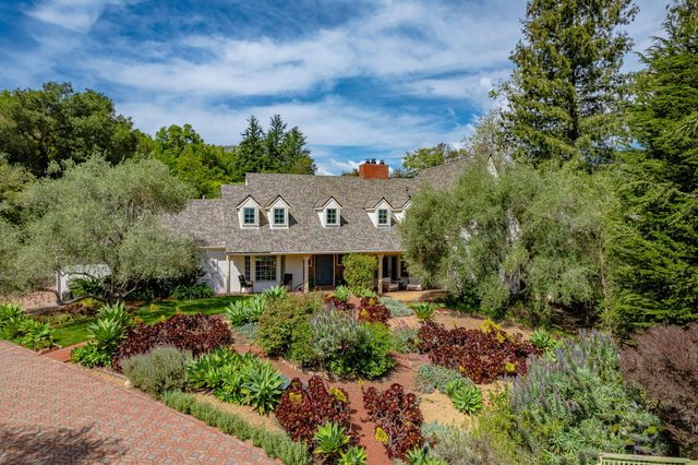 a view of a house with a yard and garden