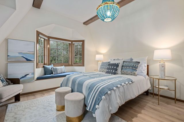 a bedroom with bed and a large window