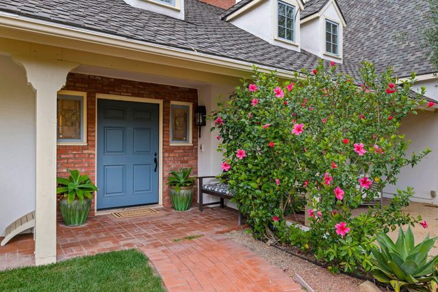 a flower garden is sitting in front of a house