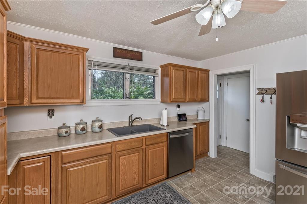 127 Queentown Road Canton, NC 28716 - Photo 11 of 43 a kitchen with stainless steel appliances granite countertop a sink stove and refrigerator
