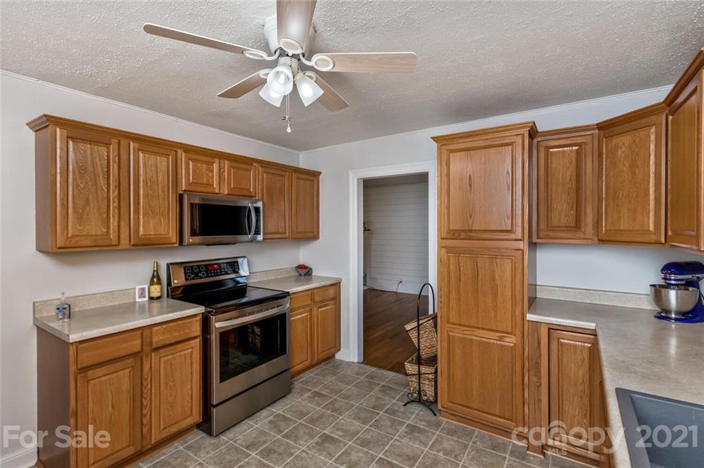 127 Queentown Road Canton, NC 28716 - Photo 12 of 43 a kitchen with stainless steel appliances granite countertop a stove a sink dishwasher and a refrigerator