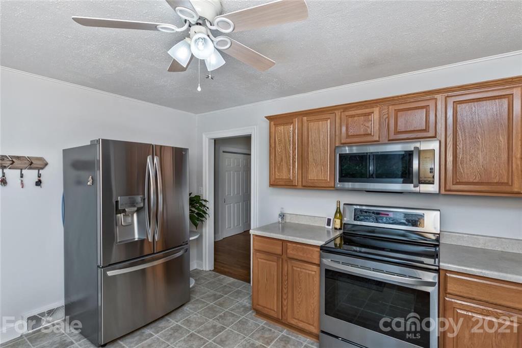 127 Queentown Road Canton, NC 28716 - Photo 14 of 43 a kitchen with stainless steel appliances granite countertop a refrigerator and a stove top oven