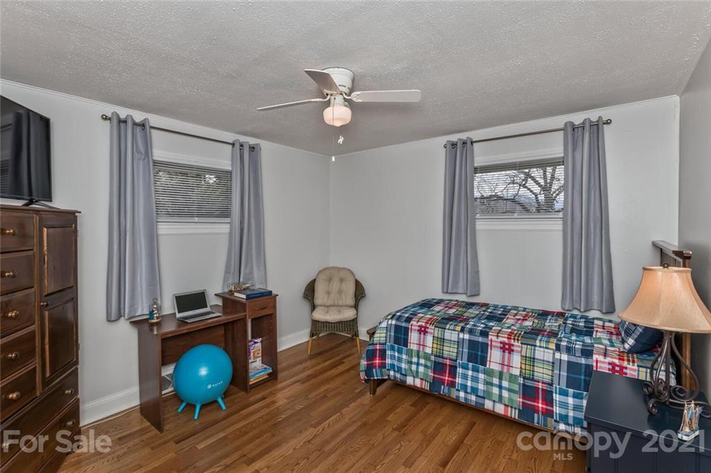 127 Queentown Road Canton, NC 28716 - Photo 15 of 43 a bedroom with bed and a chandelier