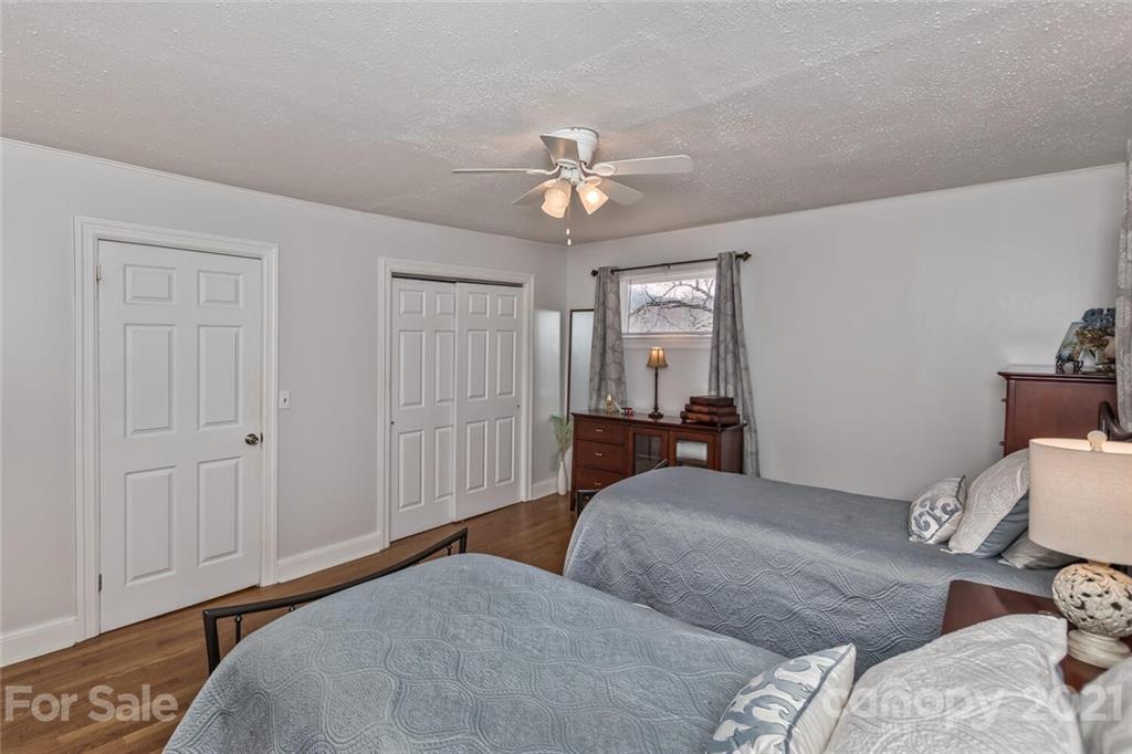 127 Queentown Road Canton, NC 28716 - Photo 18 of 43 a bedroom with a bed and a chandelier