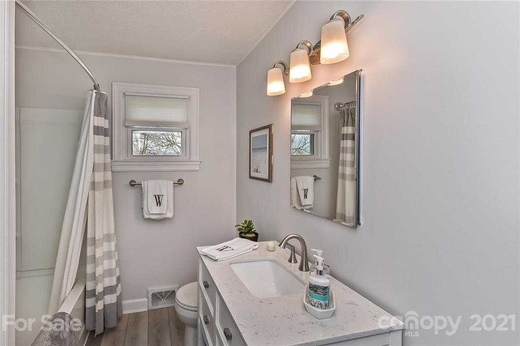 127 Queentown Road Canton, NC 28716 - Photo 19 of 43 a bathroom with a sink vanity and a mirror
