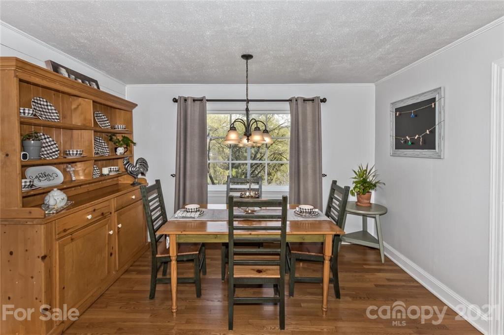 127 Queentown Road Canton, NC 28716 - Photo 9 of 43 a dining room with furniture a window and wooden floor