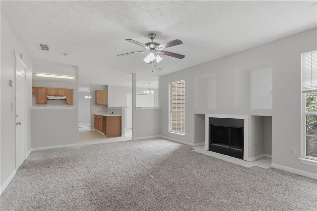 2191 Phillips Road Lithonia, GA 30058 - Photo 12 of 41 a view of an empty room with a fireplace and a window