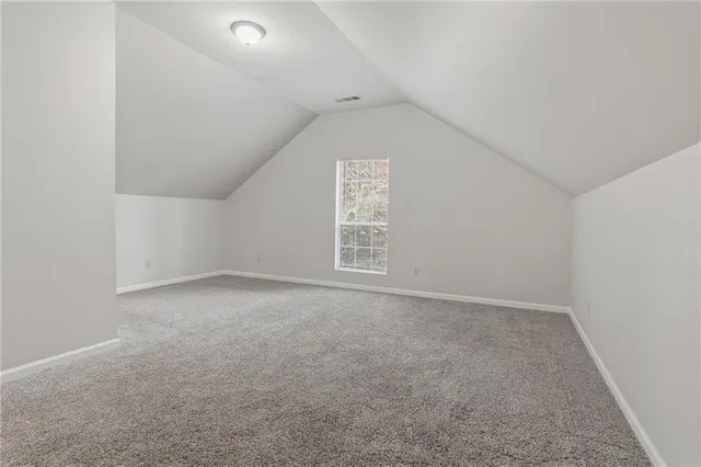 an empty room with a empty space and windows