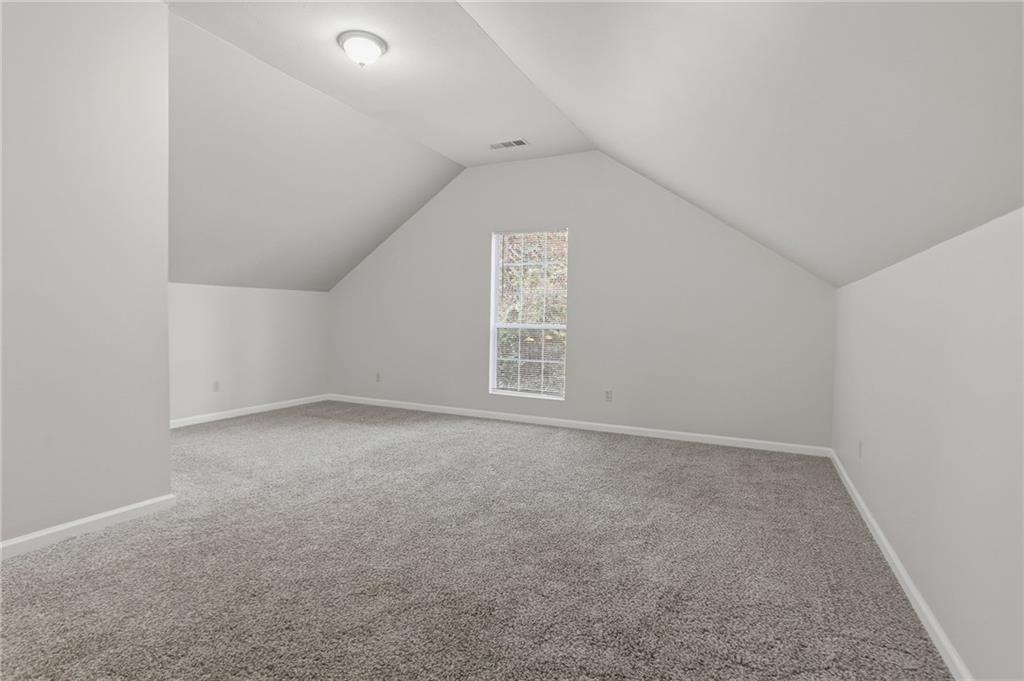 2191 Phillips Road Lithonia, GA 30058 - Photo 16 of 41 an empty room with a empty space and windows