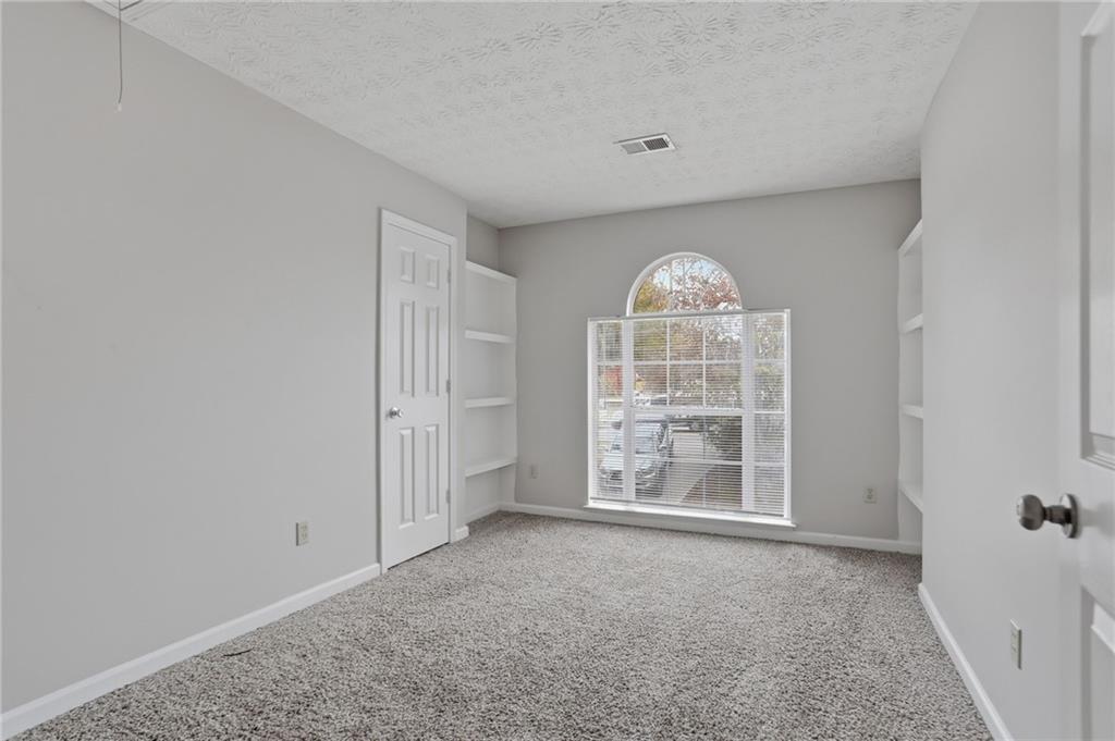 2191 Phillips Road Lithonia, GA 30058 - Photo 21 of 41 an empty room with windows