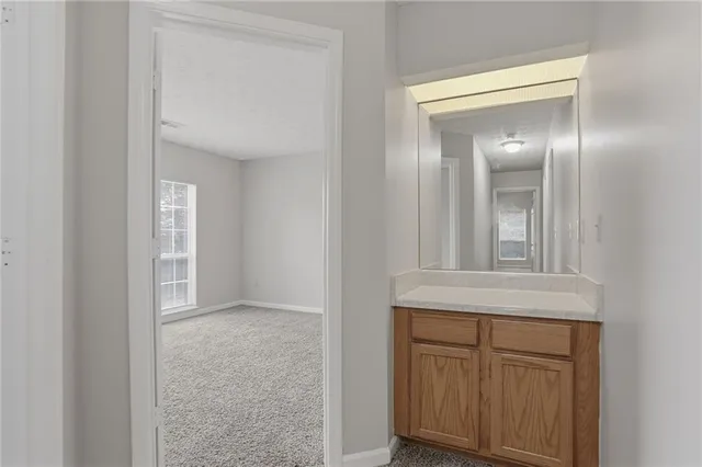 a view of an empty room with a ceiling fan and a window