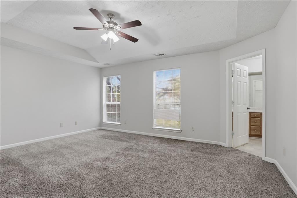 2191 Phillips Road Lithonia, GA 30058 - Photo 24 of 41 a view of an empty room with a ceiling fan and a window