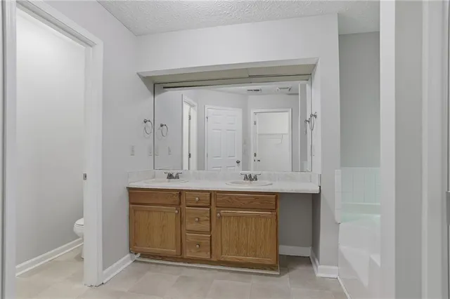 a bathroom with a tub sink and mirror
