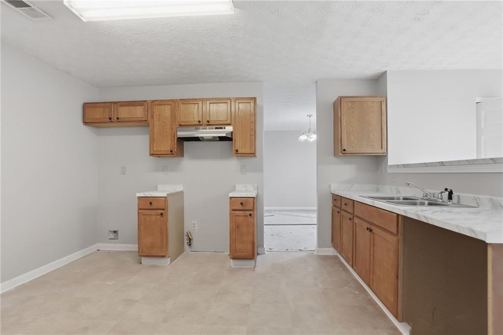 2191 Phillips Road Lithonia, GA 30058 - Photo 4 of 41 a kitchen with a sink and a stove top oven