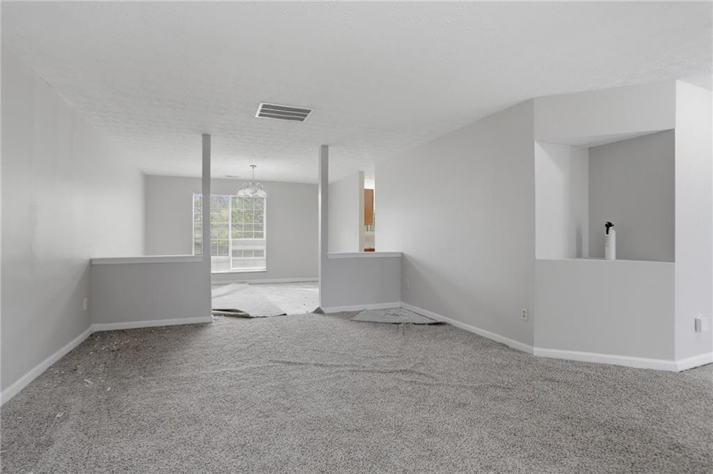 2191 Phillips Road Lithonia, GA 30058 - Photo 8 of 41 a view of an empty room with kitchen and a window