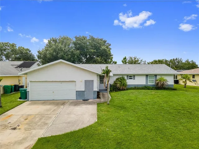 a view of a yard in front of a house with a big yard