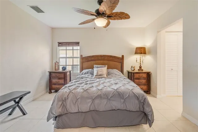 a bedroom with a bed and a ceiling fan