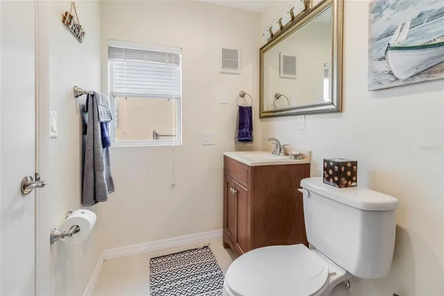 a white toilet sitting next to a bathroom sink