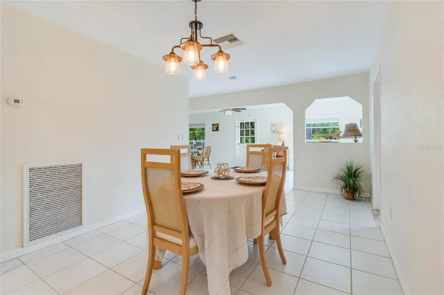 a view of a dining room with furniture and chandelier