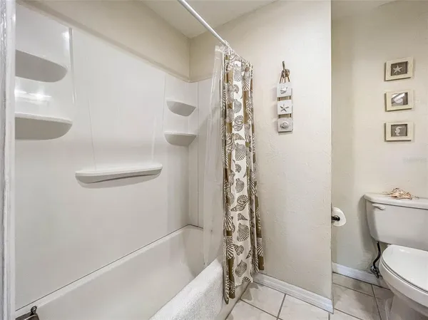 a bath room with a toilet and a bath tub