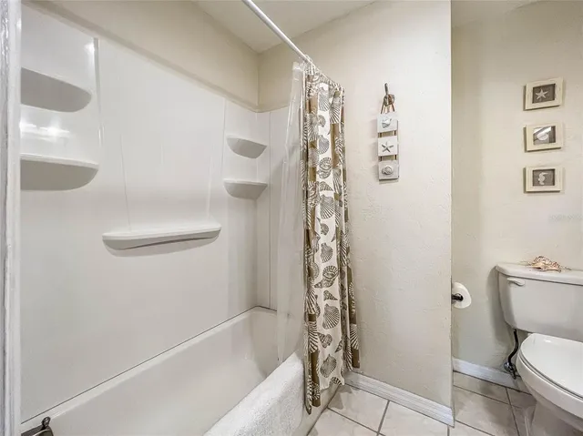 a bath room with a toilet and a bath tub