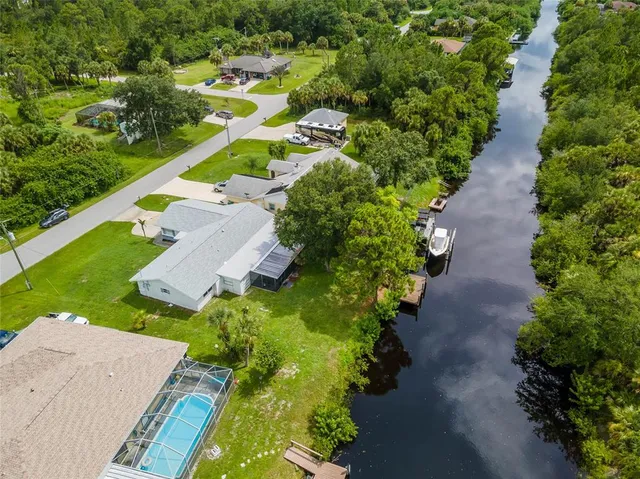 an aerial view of a house with a yard