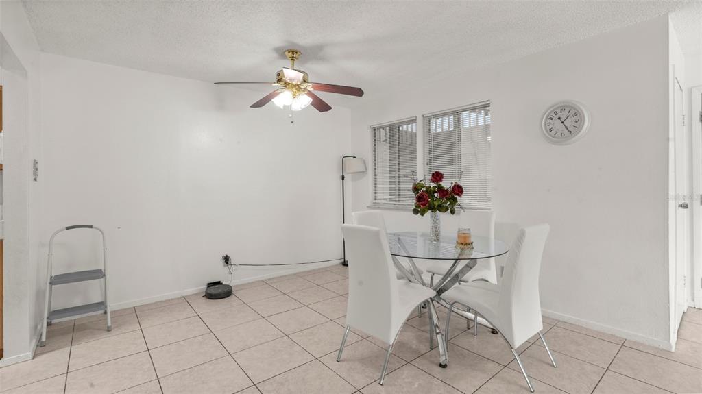 6519 West Newberry Road, Unit 912 Gainesville, FL 32605 - Photo 13 of 47 a view of a dining room with furniture and chandelier