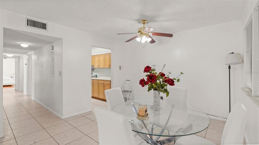 6519 West Newberry Road, Unit 912 Gainesville, FL 32605 - Photo 14 of 47 a view of a dining room with furniture and chandelier
