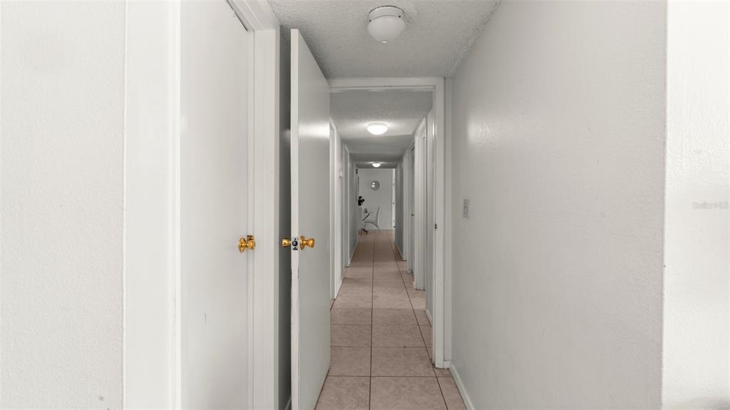 6519 West Newberry Road, Unit 912 Gainesville, FL 32605 - Photo 21 of 47 a view of a bathroom from a hallway