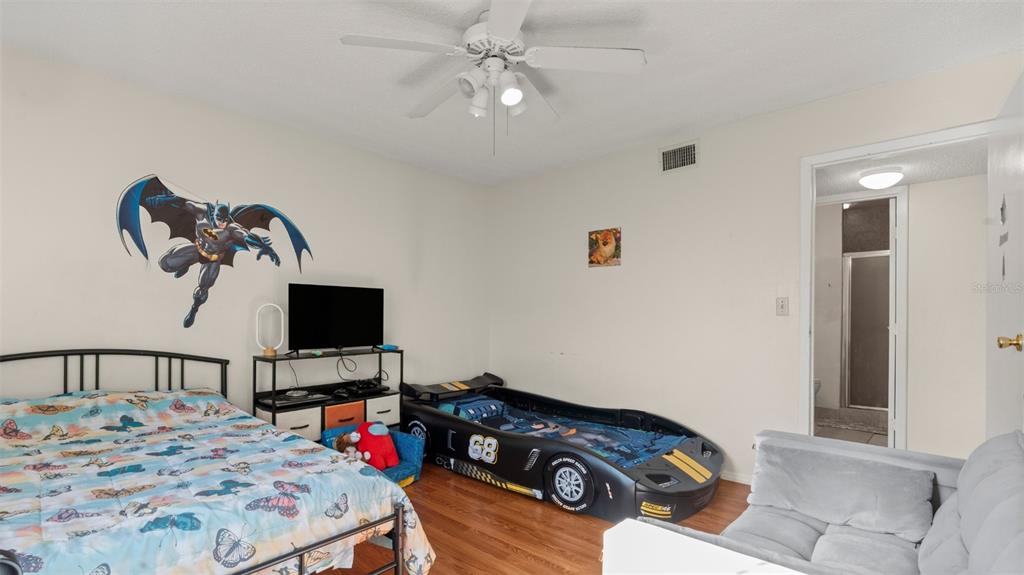 6519 West Newberry Road, Unit 912 Gainesville, FL 32605 - Photo 25 of 47 a bedroom with a bed and a flat screen tv