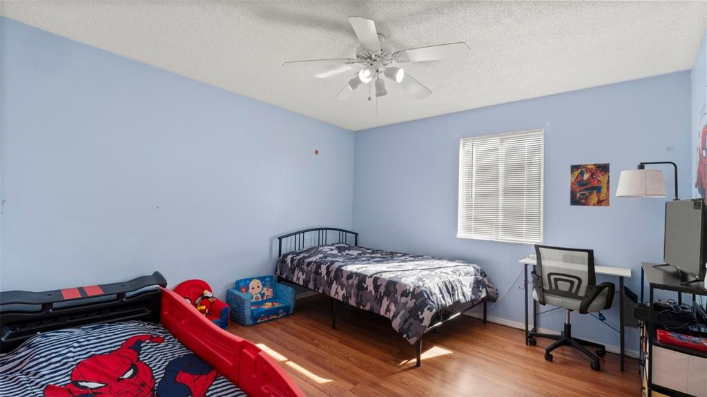 6519 West Newberry Road, Unit 912 Gainesville, FL 32605 - Photo 27 of 47 a bedroom with a bed and a chandelier