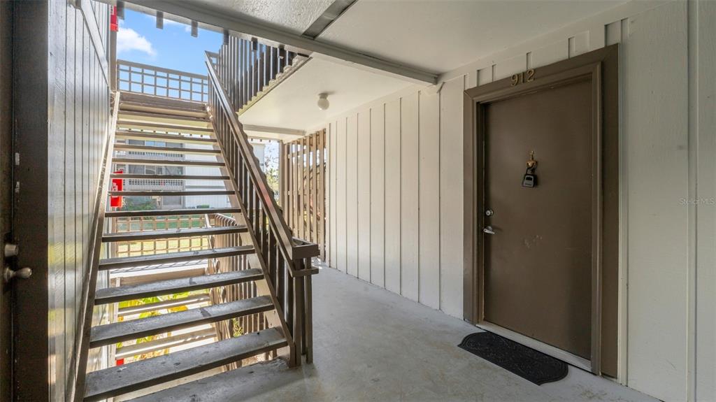 6519 West Newberry Road, Unit 912 Gainesville, FL 32605 - Photo 8 of 47 a view of entryway with stairs and wooden floor