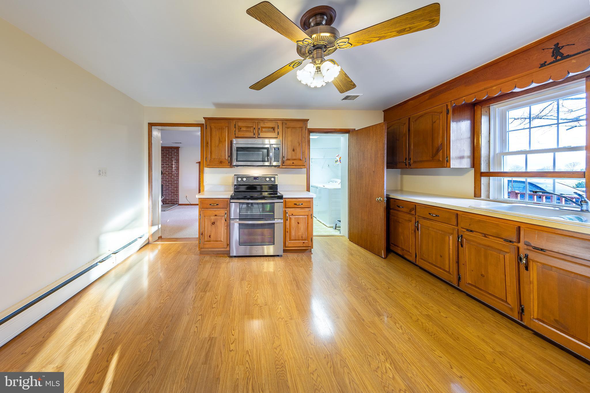 23045 Watson Road Leesburg, VA 20175 - Photo 12 of 69 a kitchen with stainless steel appliances a stove top oven and a refrigerator