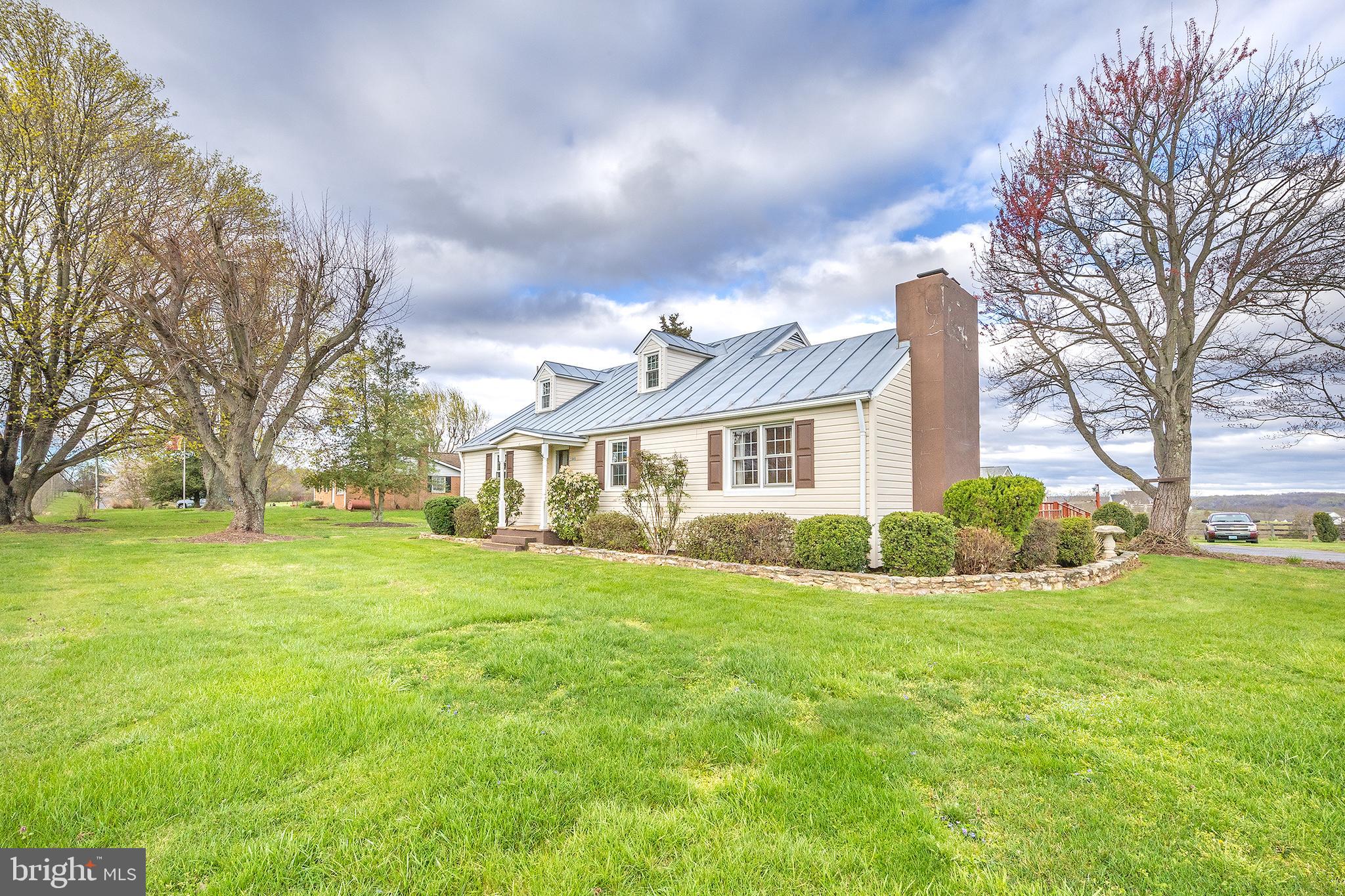 23045 Watson Road Leesburg, VA 20175 - Photo 3 of 69 a view of a house with a big yard and large trees