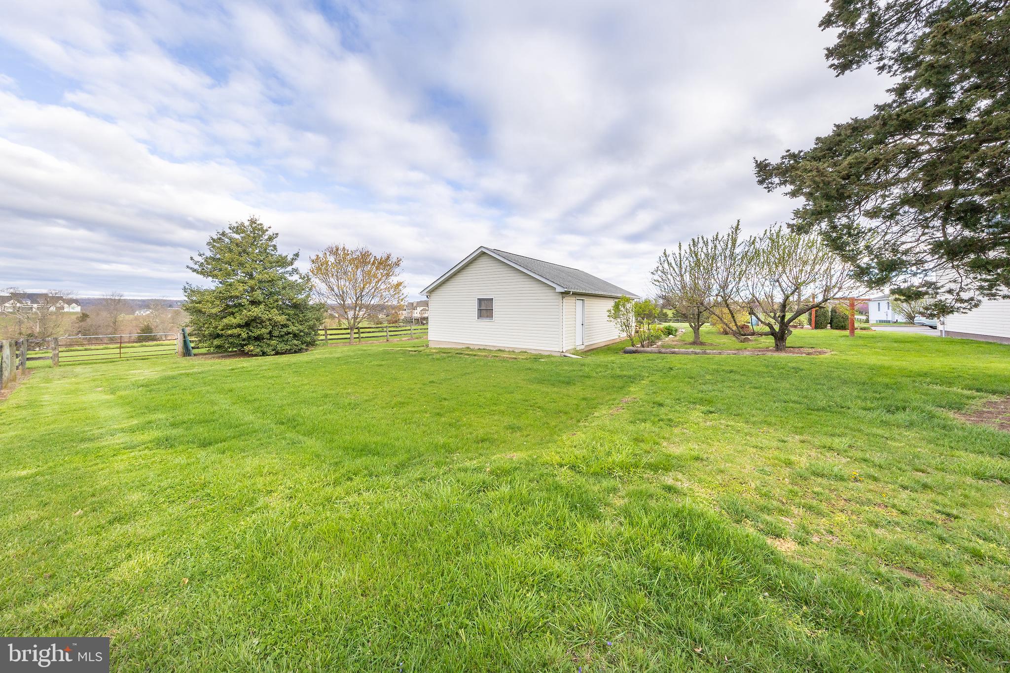 23045 Watson Road Leesburg, VA 20175 - Photo 46 of 69 a view of a house with a big yard and a large tree