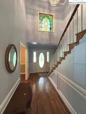 a view of a livingroom with wooden floor and a window