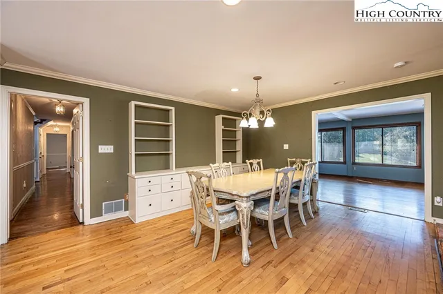 a view of a dining room with furniture and window