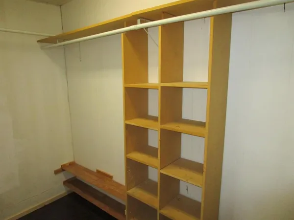 a living room with hard wood floor and a window
