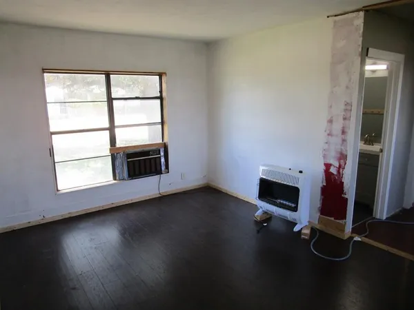 a view of a living room with wooden floor