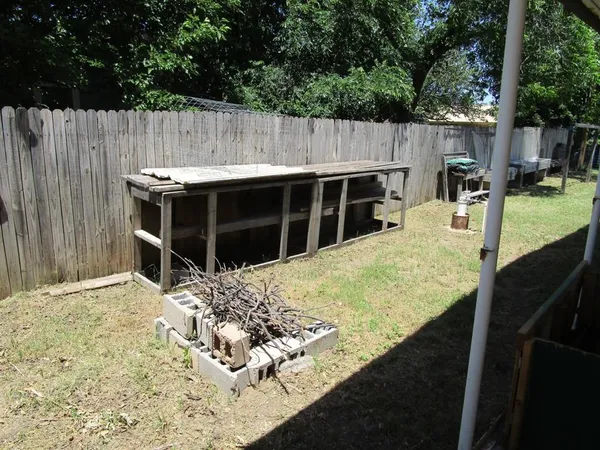 a view of a backyard with a wooden fence