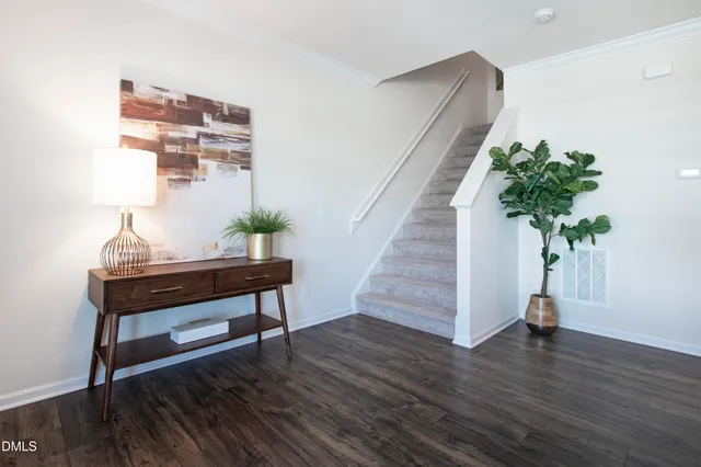 a view of a workspace room with wooden floor and potted plant